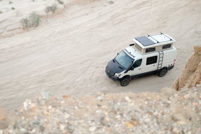 A custom Sportsmobile Sprinter 4x4 conversion camper featuring an expanded penthouse top.