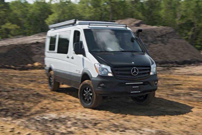 A custom Sportsmobile Sprinter 4x4 camper conversion traveling offroad through the Mojave desert.