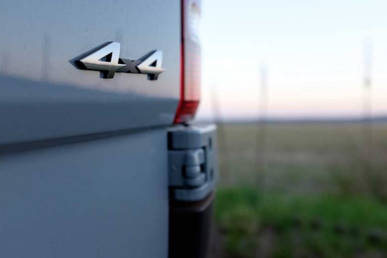 A close up of a custom Sportsmobile Sprinter 4x4 camper emblem.