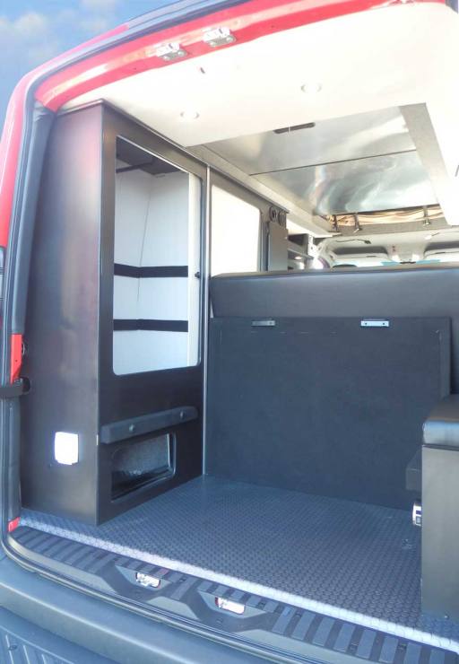 Sportsmobile camper van converison with plenty of storage in the rear.