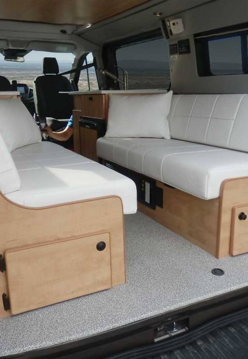 Interior Transit camper view with white dinette.