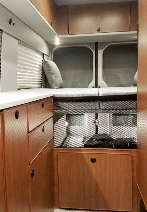 Interior view of a Sportsmobile Sprinter EB custom camper van conversion.