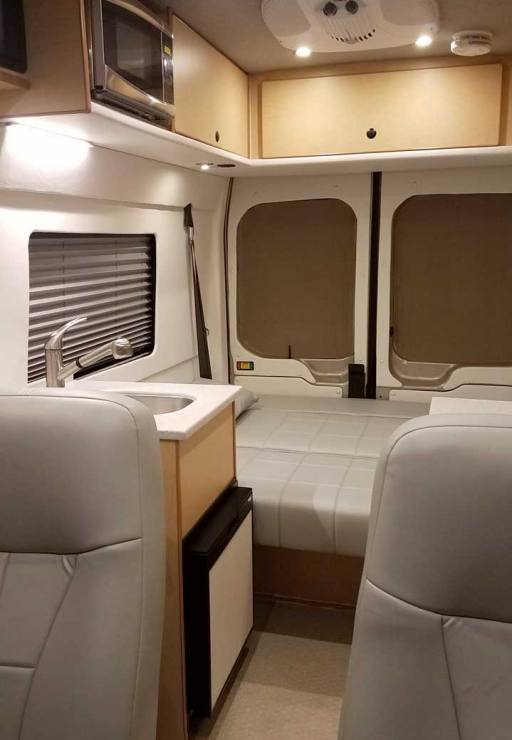 Interior view of a custom Sportsmobile Transit conversion van with high roof.