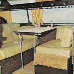 1970s Sportsmobile Clubcar conversion van interior featuring a dining area.