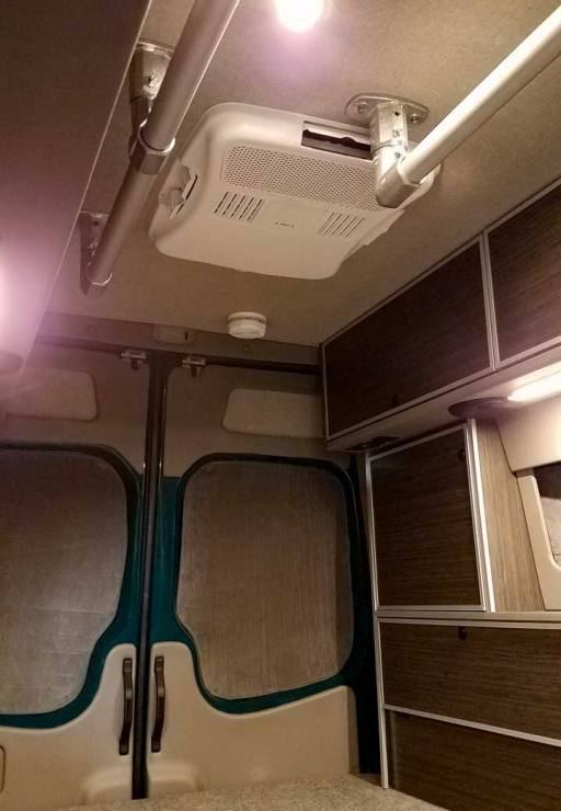 Interior view of a Sportsmobile Sprinter with accessibility rails.