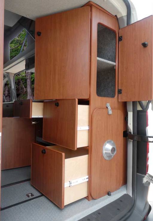 Interior view of a custom Sportsmobile Sprinter van conversion with plenty of storage.