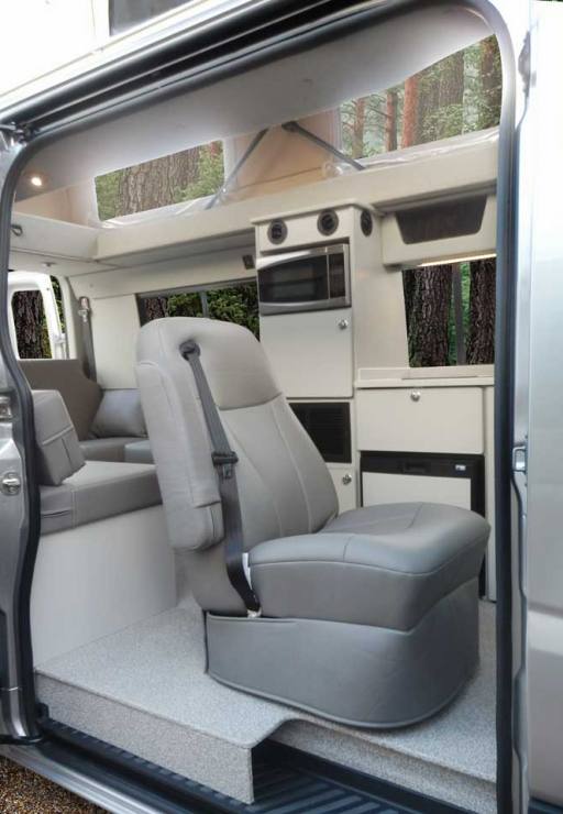 Custom Mercedes-Benz conversion van with slide door open and penthouse pop top extended.