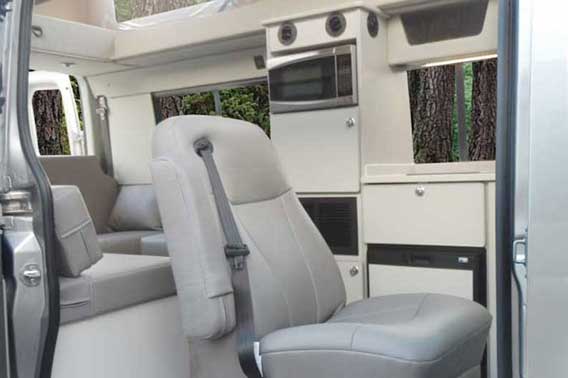 Van conversion with grey leather and Baltic Birch cabinets.