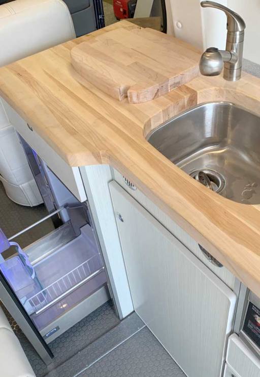 Custom Sprinter conversion van with butcher block countertop.