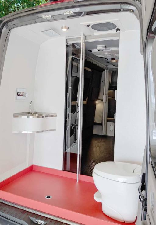 Bath area in the rear of van with shower and toilet.