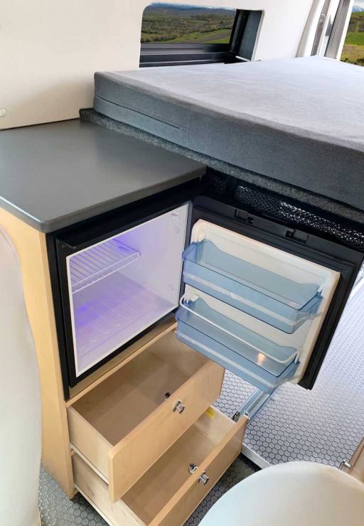 Galley view of the the refrigerator and cabinets.