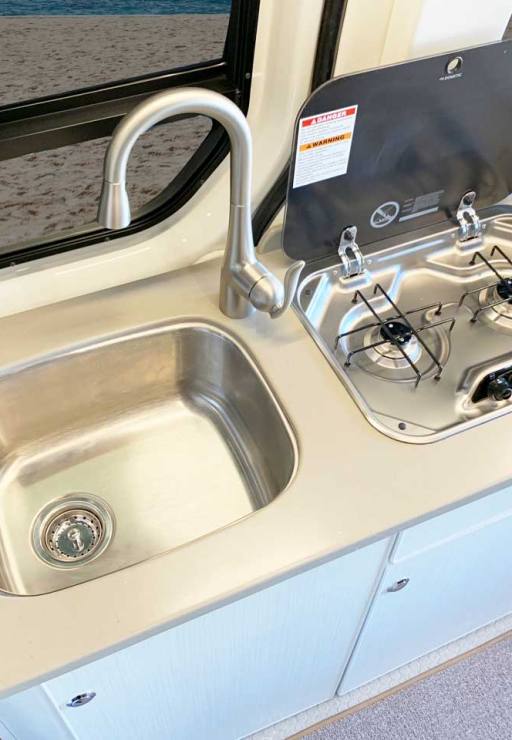 Propane cooktop and sink in the galley.