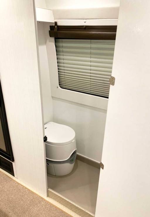 Bath compartment features toilet and shower.