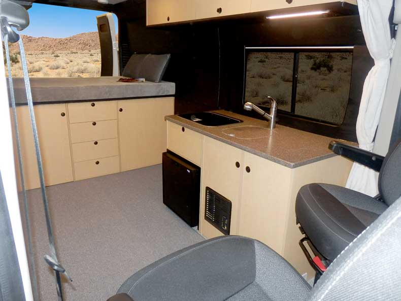 Custom Sportsmobile Promaster conversion van featuring a platform bed.