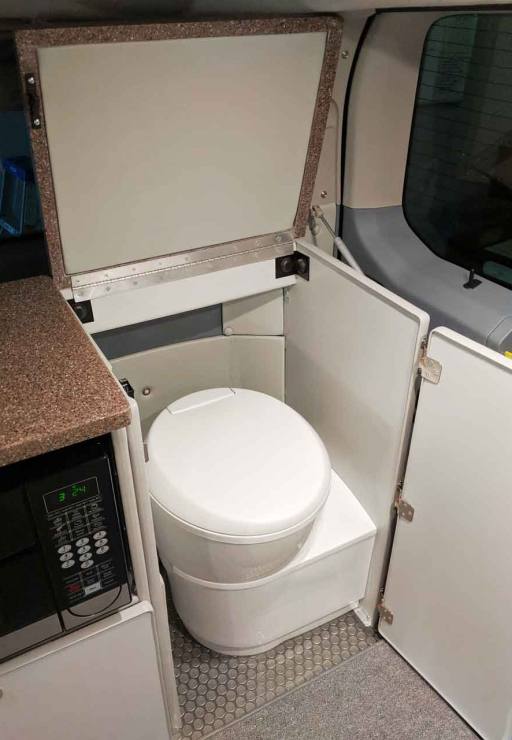 Out of site cassette toilet in rear compartment.