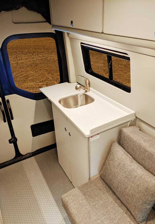 Sink cabinet in rear of van.